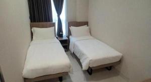 Uma cama ou camas num quarto em WE Hotel Kowloon