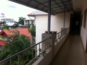 a balcony with a view of a building at Pikul Apartment Hotel in Nong Khai