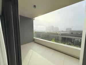 a room with a large window with a view of a city at Flower Nest Apartment in Moka