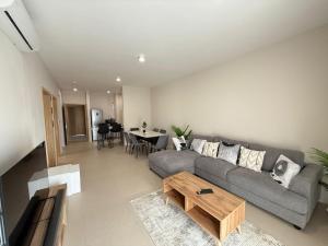 a living room with a couch and a table at Flower Nest Apartment in Moka
