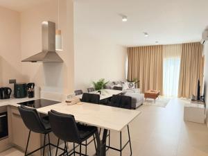 a kitchen and living room with a table and a couch at Flower Nest Apartment in Moka