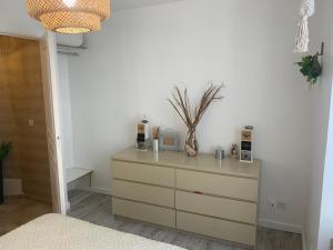 a dresser in a room with a white wall at Le Cosy in Mer