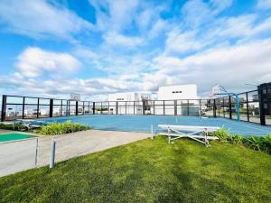 a tennis court on the roof of a building at Our Gentle Nest at Batulao in Calo