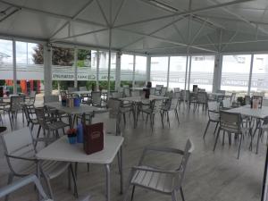 an empty restaurant with tables and chairs and windows at Hostal Sali in Pelabravo +46 photos