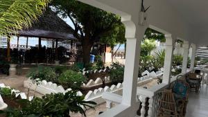 a white staircase leading to a garden with plants at Zanzi beach hotel in Nungwi