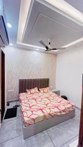 a bed in a room with a ceiling at 7th Heaven Hotel in Hisār
