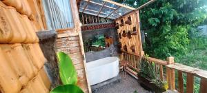 a bathroom with a bath tub in a building at Wisnu Lumbung Uluwatu in Uluwatu