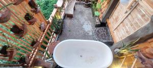 an overhead view of a white toilet in a courtyard at Wisnu Lumbung Uluwatu in Uluwatu