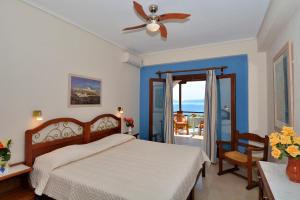 a bedroom with a bed and a ceiling fan at Diplomats' Holidays in Chorto