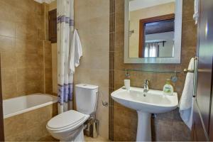 a bathroom with a toilet and a sink and a mirror at Diplomats' Holidays in Chorto +47 photos