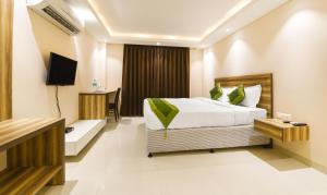 Letto o letti in una camera di Treebo Iffco Chowk