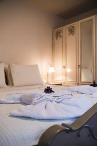 a bedroom with two beds with towels on them at Palaeopoli Villas in Avlemonas