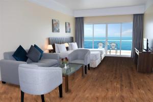 A bed or beds in a room at Ramada by Wyndham Beach Hotel Ajman