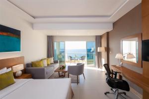 A bed or beds in a room at Ramada by Wyndham Beach Hotel Ajman