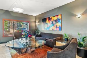 a living room with a couch and a glass table at Radisson Hotel Portland Airport in Portland