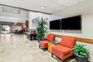 an office lobby with two chairs and a flat screen tv at Radisson Hotel Portland Airport in Portland