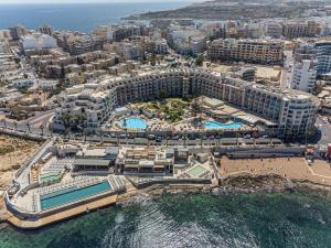 an aerial view of a resort and the ocean at DoubleTree by Hilton Malta in St Paul's Bay
