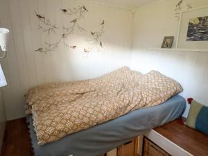 a bed in a room with a pillow on the wall at 8 person holiday home in frosta in Vollen +16 photos