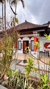 a small house with a lot of plants in front of it at Villa Lumba Lumba Candidasa in Candidasa