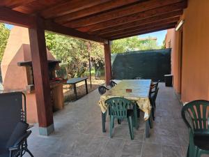 a wooden table and chairs on a patio at Villa Giulia Grande in Castiadas