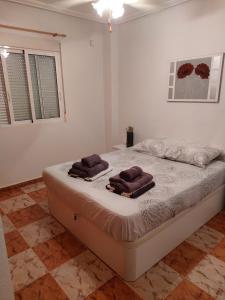a bedroom with a bed with two towels on it at Lima in Orihuela Costa +23 photos