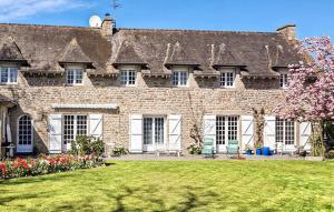 a large brick building with a lawn in front of it at Gorgeous Home In Plélan-Le-Petit in Plélan-le-Petit
