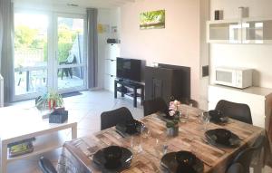 a kitchen with a wooden table and a dining room at 2 Bedroom Lovely Home In Westende in Middelkerke