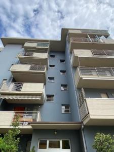 a tall apartment building with solar panels on it at VARIE STRUTTURE Queste strutture NON FORNISCE lenzuola da letto e asciugamani in Lido Adriano +2 photos
