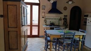 a kitchen with a table and chairs in a kitchen at Rustic-style apartment in LMP +9 photos