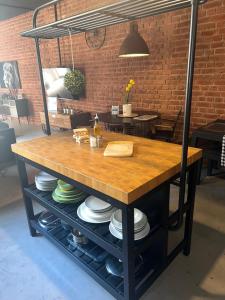 a table with plates on it in a room at Industrial Cozy Gzira Apt, Prime Spot, Sep Deal in Il-Gżira +24 photos