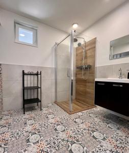 a bathroom with a shower and a sink at Azur Dream by the Lake in Zamárdi