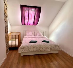 a bedroom with a bed with a pink window at Azur Dream by the Lake in Zamárdi