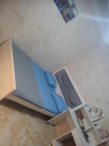 a small bed with blue pillows in a room at Home sweet home 2 bed with a living room in Batna +11 photos