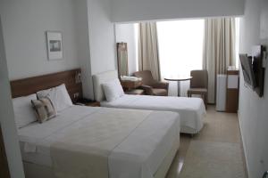 a hotel room with two beds and a television at AGZ Hotel in Dikili