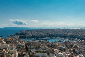 an aerial view of a city with buildings and water at New! Green & Blue Castella Luxury Suites-fully furnished best location in Piraeus 300 Mbps WiFi in Piraeus +88 photos