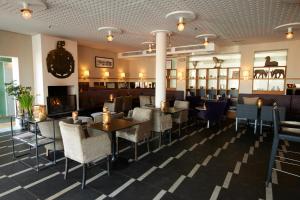 a restaurant with tables and chairs and a checkered floor at Villa Källhagen in Stockholm