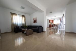 a living room with a couch and a table at Vasilis Villa in Phanaes