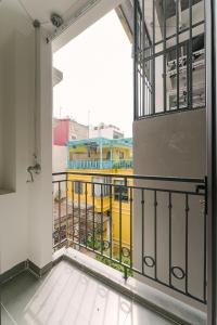 a view of a yellow bus from a balcony at Boho Apartment 81 - Ton That Thiep in Hanoi