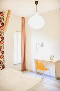 a bedroom with a bed and a desk and a chair at Modern Guesthouse Near Åsnen National Park in Jät
