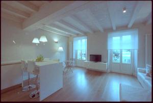 a large room with a kitchen and a living room at La Casa Del Porto in Lovere