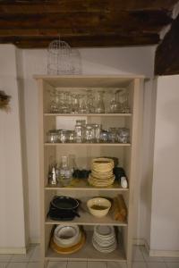 a pantry with dishes and glasses and plates at Appartamento del Campo in Siena