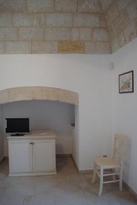 a room with a desk and a chair and a brick wall at Il Terrazzino in Laterza