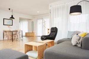 a living room with a couch and a table at Vlnka Apartments in Piešťany