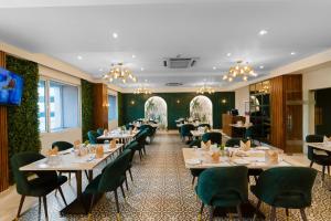 a dining room with tables and chairs at Grand Plaza Jammu in Jammu