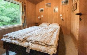 a bed in a room with a window at Gorgeous Home In Ulfborg With Wifi in Ulfborg +3 photos