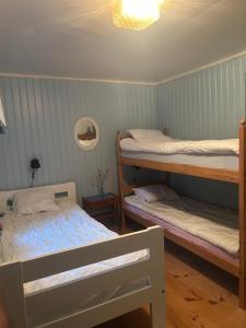 a bedroom with two bunk beds and a lamp at Skänninge Vimmerby in Vimmerby