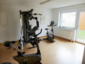 a gym with treadmills and exercise bikes in a room at 1-raum-ferienwohnung Im 4 Og in Cuxhaven