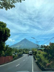 a road with a mountain in the distance at Casa Domingo Guest House in Camalig
