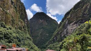 a view of a canyon with trees and mountains at Vista Waynapata 1 23 in Machu Picchu