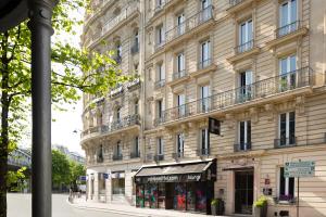 a large building with a store in front of it at Residence Paris Eiffel in Paris